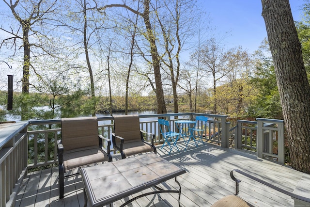 wooden terrace featuring a water view