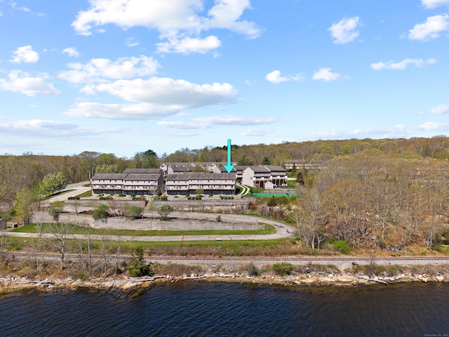 drone / aerial view featuring a water view and a view of trees
