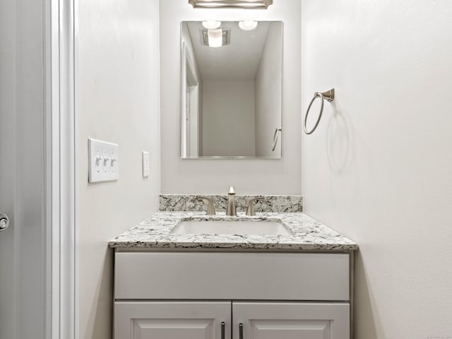 bathroom with vanity and visible vents