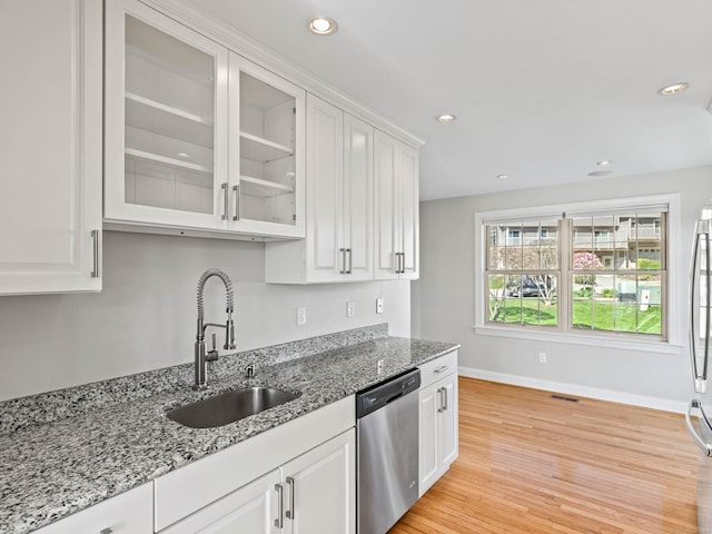 kitchen featuring a sink, baseboards, white cabinets, glass insert cabinets, and stainless steel appliances