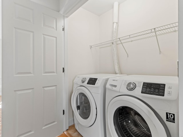 clothes washing area featuring laundry area and washing machine and dryer