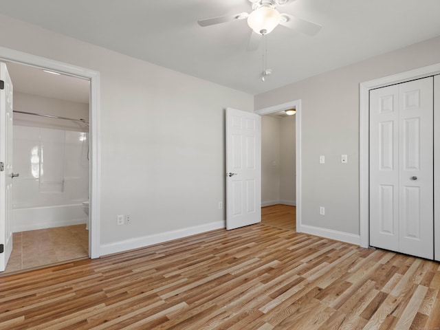 unfurnished bedroom featuring a closet, baseboards, and light wood-type flooring
