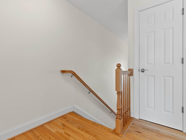 stairway featuring baseboards and wood finished floors