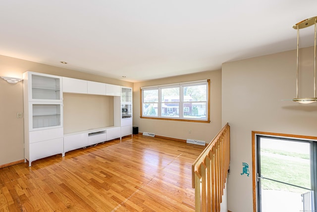 185 Daniel Rd, Hamden, CT 06517 - unfurnished living room with visible vents, light wood finished floors, and baseboards