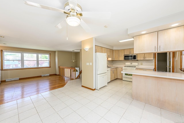 185 Daniel Rd, Hamden, CT 06517 - kitchen featuring light brown cabinetry, white appliances, light countertops, open floor plan, and visible vents