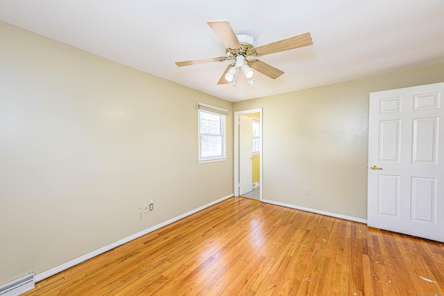 185 Daniel Rd, Hamden, CT 06517 - unfurnished room with baseboards, ceiling fan, a baseboard heating unit, and light wood-type flooring