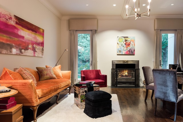 living area featuring a warm lit fireplace, an inviting chandelier, recessed lighting, wood finished floors, and ornamental molding
