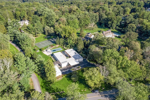 birds eye view of property featuring a wooded view