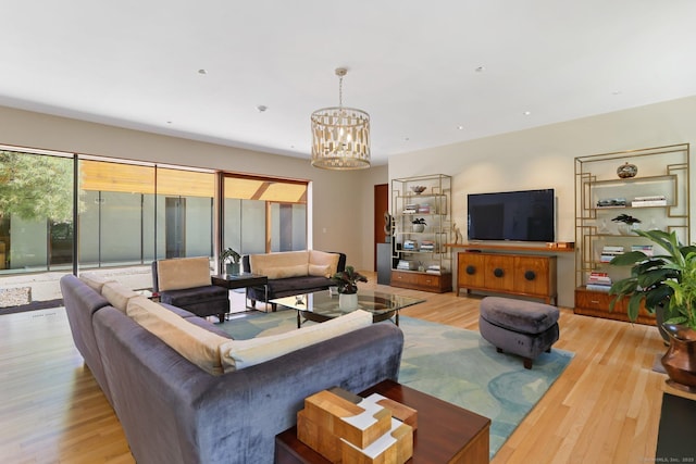 living area with a chandelier and wood finished floors