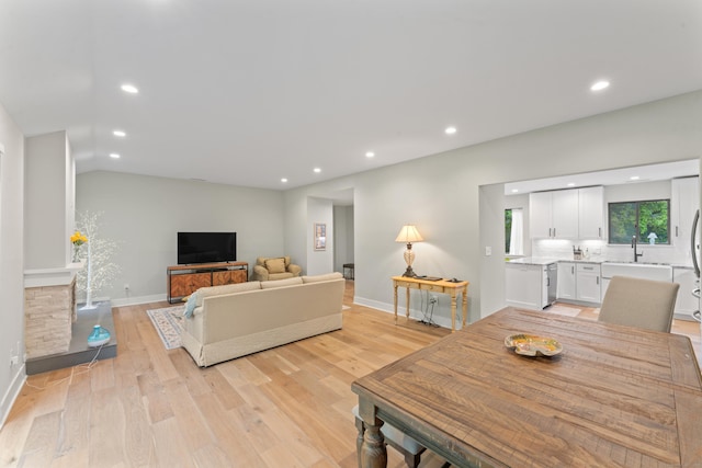 living area featuring recessed lighting, light wood finished floors, baseboards, and lofted ceiling