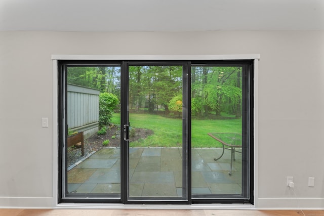 doorway to outside featuring baseboards