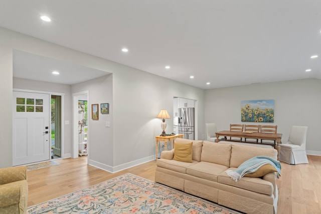 living area featuring light wood-type flooring, recessed lighting, and baseboards