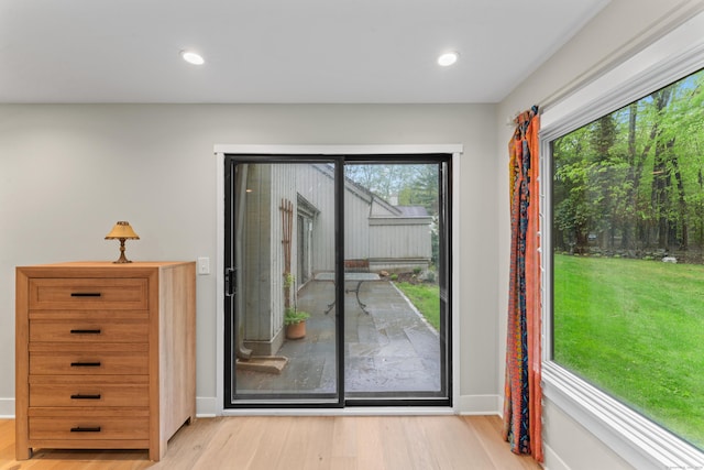 entryway with wood finished floors, baseboards, and recessed lighting
