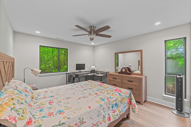 bedroom featuring wood finished floors, recessed lighting, baseboards, and ceiling fan