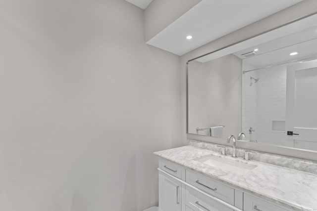 bathroom featuring vanity, recessed lighting, and a shower