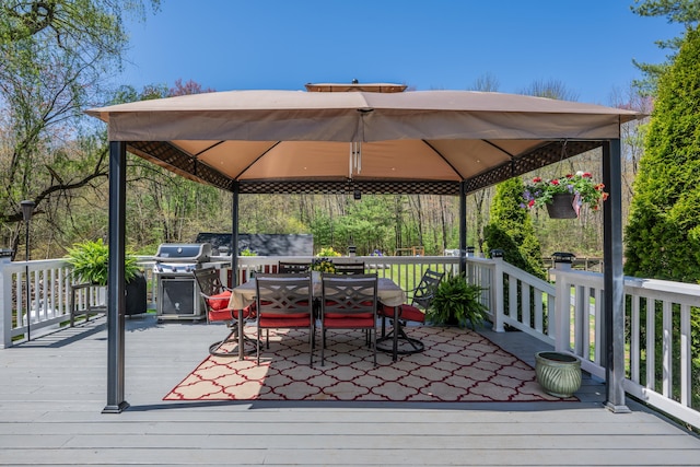 wooden deck with grilling area, a gazebo, and outdoor dining space