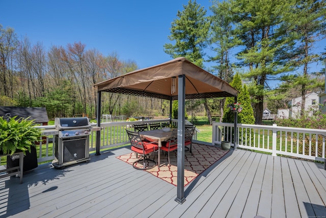 deck featuring a lawn, outdoor dining space, a gazebo, and a grill
