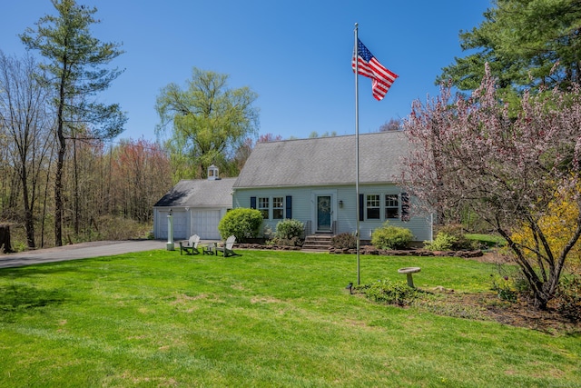 view of front facade with a garage, a front yard, and aphalt driveway