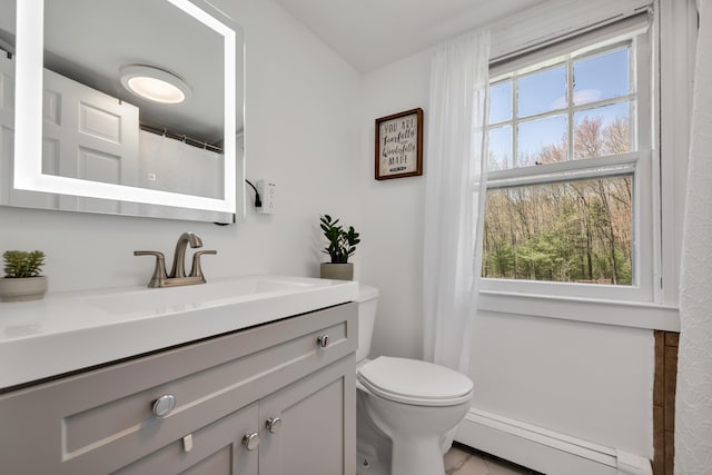 bathroom with vanity, a baseboard radiator, and toilet
