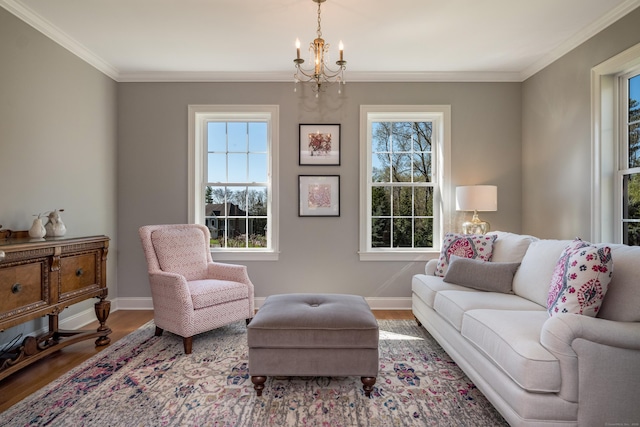 living area featuring crown molding, baseboards, an inviting chandelier, and wood finished floors