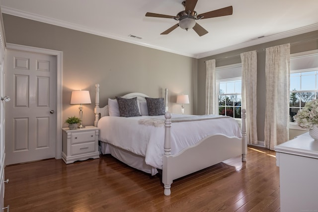 bedroom with visible vents, dark wood-style flooring, crown molding, and ceiling fan