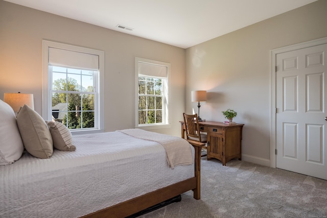 carpeted bedroom with visible vents and baseboards