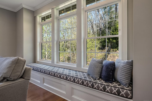 sitting room featuring crown molding, plenty of natural light, and dark wood-type flooring