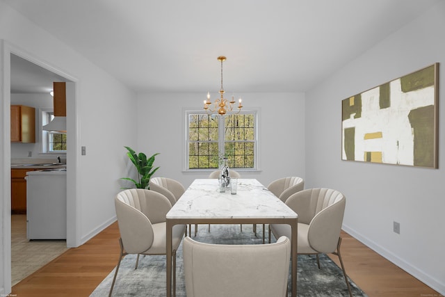 4 Davis Farm Rd, Clinton, CT 06413 - dining area featuring a chandelier, plenty of natural light, light wood finished floors, and baseboards