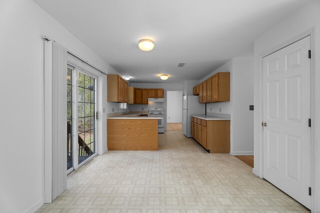 4 Davis Farm Rd, Clinton, CT 06413 - kitchen with white appliances, a sink, under cabinet range hood, light countertops, and brown cabinets