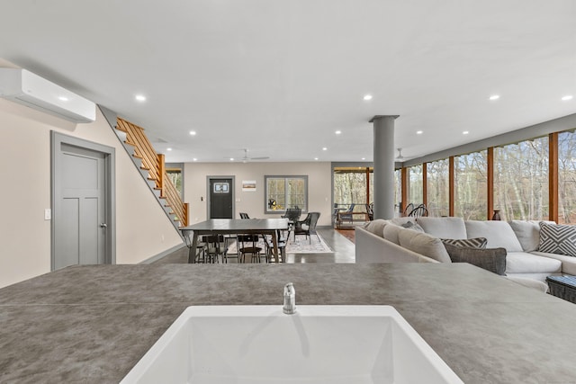 32 Cream Pot Rd, Clinton, CT 06413 - living room with ceiling fan, an AC wall unit, recessed lighting, and stairs