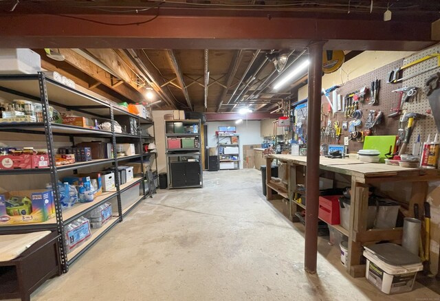 unfinished basement featuring a workshop area