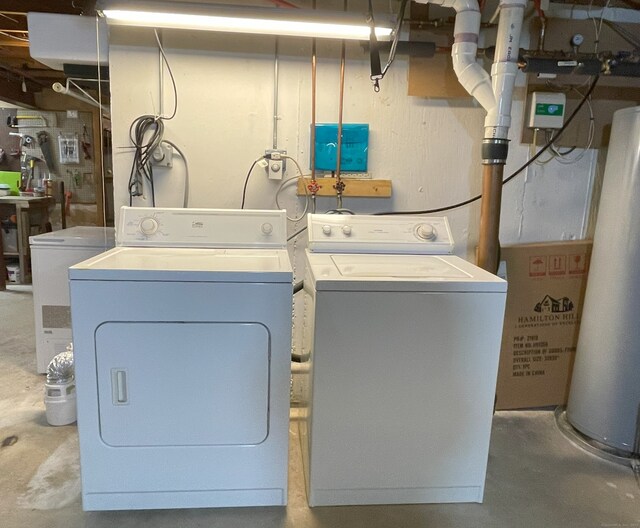 washroom featuring washing machine and dryer and gas water heater