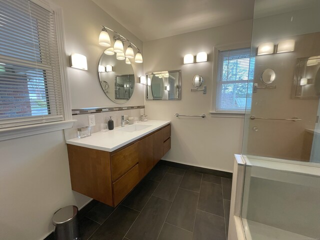 full bath featuring plenty of natural light, vanity, tasteful backsplash, and tile patterned flooring