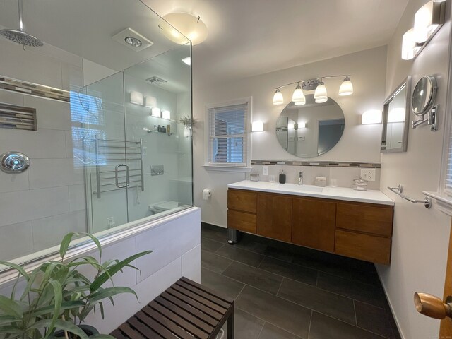 bathroom featuring a shower stall, backsplash, vanity, and tile patterned floors