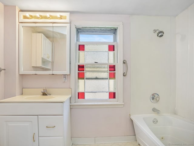 bathroom with baseboards, shower / tub combination, and vanity