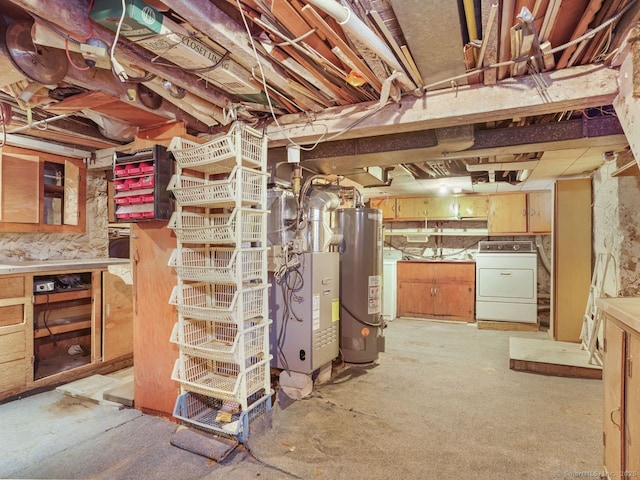 unfinished basement featuring separate washer and dryer and gas water heater