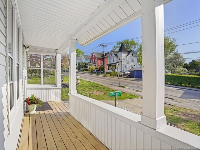 wooden deck with a porch and a residential view