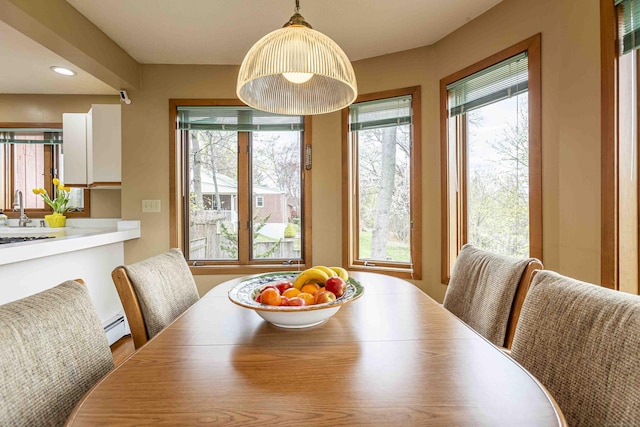 dining room with recessed lighting and a baseboard heating unit