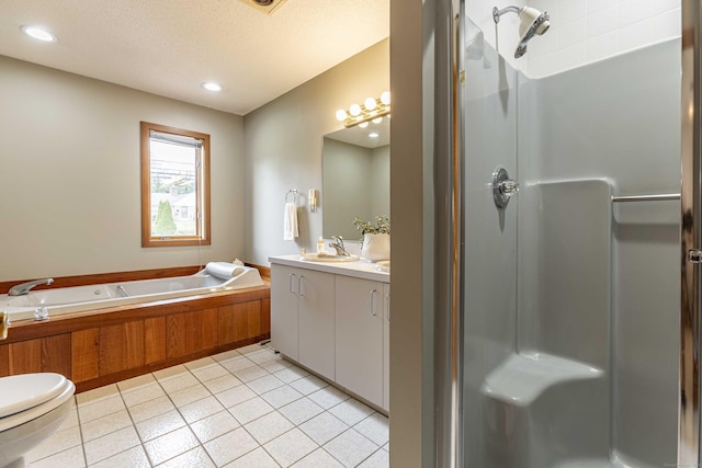 full bath featuring a shower stall, a garden tub, tile patterned flooring, and vanity