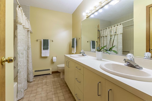 bathroom featuring toilet, double vanity, a sink, and a baseboard radiator