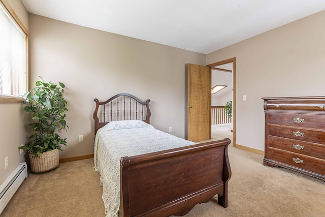 carpeted bedroom featuring baseboard heating and baseboards