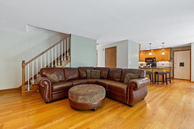 199 Dennison Rdg, Manchester, CT 06040 - living area featuring light wood-style floors, stairs, baseboards, and a textured ceiling