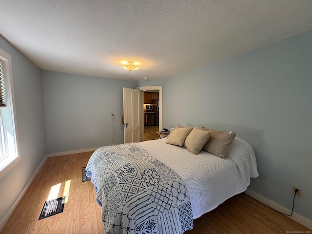 17 Green Rd, Vernon, CT 06066 - bedroom featuring baseboards, wood finished floors, and a textured ceiling