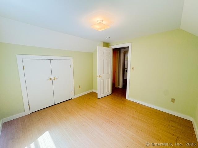 17 Green Rd, Vernon, CT 06066 - unfurnished bedroom featuring lofted ceiling, light wood finished floors, baseboards, and a closet