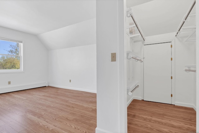 16 Copper Hill Dr Unit 16, Guilford, CT 06437 - additional living space with baseboards, a baseboard heating unit, wood finished floors, and vaulted ceiling