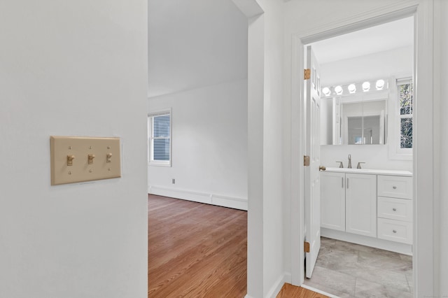 16 Copper Hill Dr Unit 16, Guilford, CT 06437 - corridor featuring a sink, baseboards, and light wood finished floors