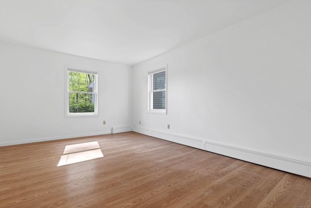 16 Copper Hill Dr Unit 16, Guilford, CT 06437 - empty room with baseboards, light wood-style flooring, and a baseboard heating unit