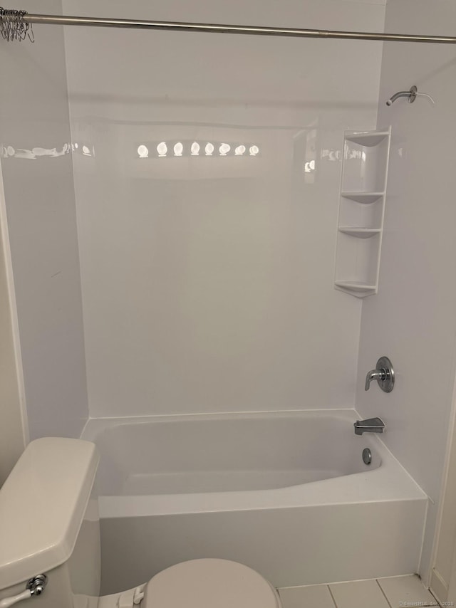 bathroom with toilet, tile patterned flooring, and tub / shower combination
