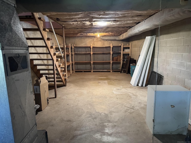 unfinished basement with concrete block wall