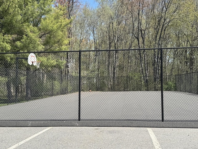 view of basketball court with fence and community basketball court